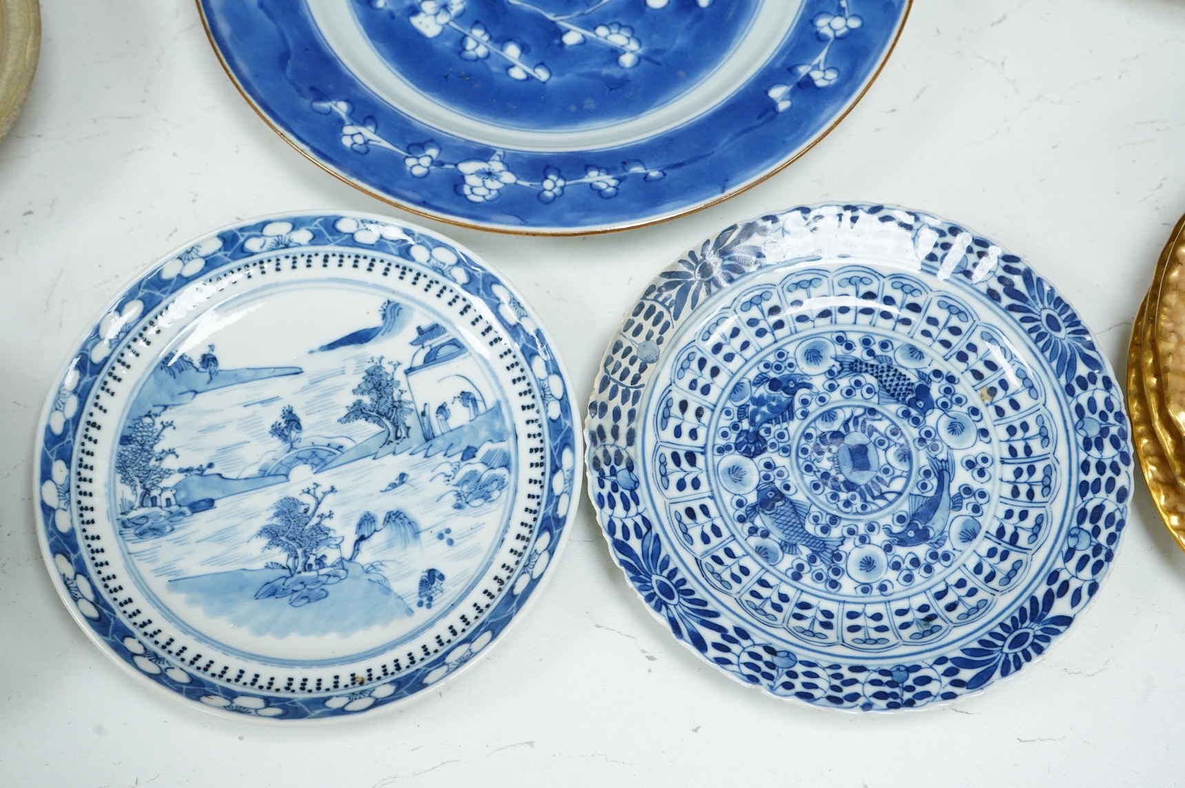 A 19th century Chinese blue landscape plate another smaller, prunus plate, another with restored rim, largest 22.5cm diameter.